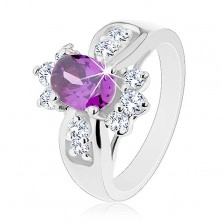 Shiny ring with widened shoulders, coloured oval zircon, round clear zircons