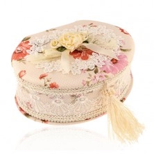 Oval jewelry box in beige colour with bouquet of flowers and bow, coloured flowers