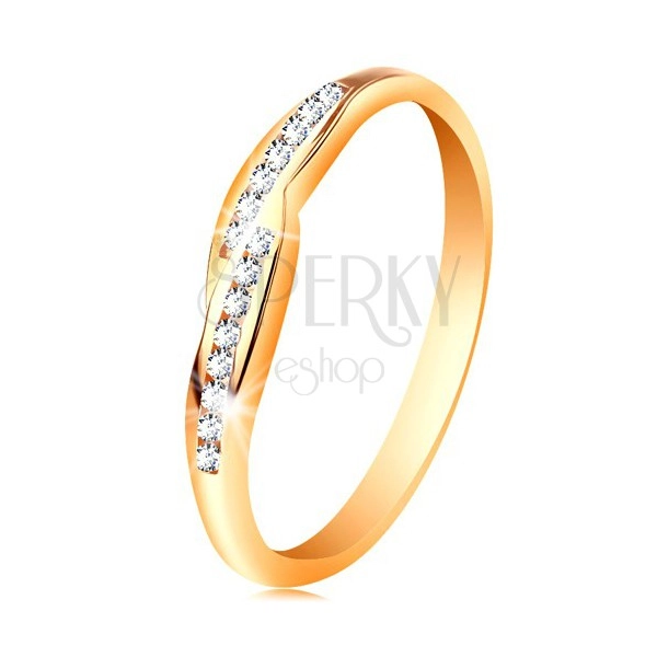 Ring made of yellow 14K gold, widened ends of shoulders with embedded zircons