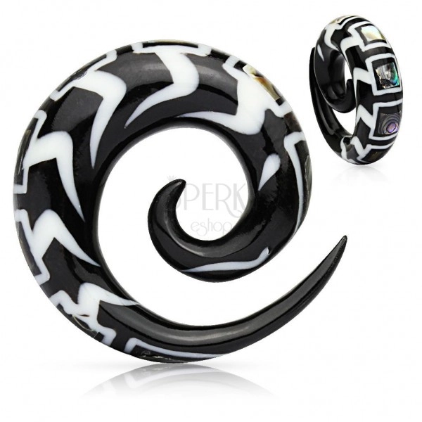Spiral patterned ear expander made of organic material, fragments of shell