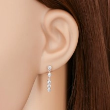 Earrings made of white 14K gold - round clear zircons in vertical line