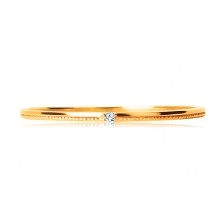 Ring made of yellow 9K gold - tiny clear zircon, delicately notched shoulders