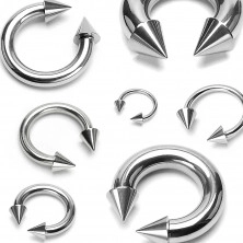 Stainless steel piercing of silver color - horseshoe finished with pikes