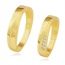 Bands in 585 yellow gold - triangular notch lined with dots, clear zircons