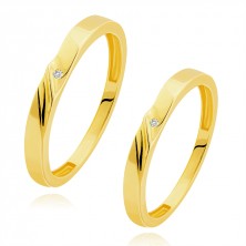 Wedding bands in 14K gold - diagonal notches, clear zircon in a dent