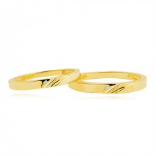 Wedding bands in 14K gold - diagonal notches, clear zircon in a dent